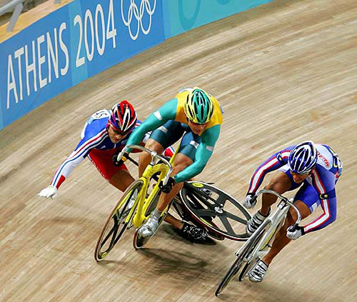 Mickael Bourgain (left) of France crashes as Australia's Shane Kelly (centre) and Malaysia's Josiah Ng pedal in the men's Kierin final at the Athens 2004 Olympic Games track cycling competition August 25, 2004.