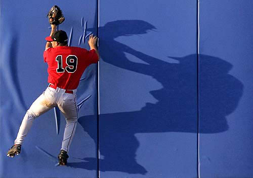 Centerfielder Adam Stern of Canada leaps to make a catch on the wall on a hit by Greece's Cory Antony Harris in the third inning of their baseball game in the Athens 2004 Olympic Games on August 18.