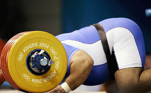Iran's Hossein Reza Zadeh prays as he celebrates his gold medal in the men's +105 kg weightlifting event at the Athens 2004 Olympics Games on August 25.