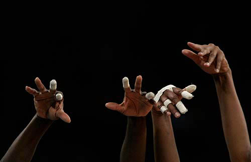Cuba's team members' hands are seen above the net during their women's quarter-final volleyball match against Italy at the Athens 2004 Olympic Games on August 24. Cuba won the match 3-2 and qualified for the semi-final, eliminating Italy.