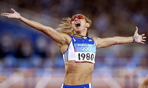 Greece's Fani Halkia celebrates as she crosses the finish line to win the women's 400 metres hurdles final at the Athens 2004 Olympic Games on August 25. Halkia won the gold medal in a time of 52.82 seconds ahead of Romania's Ionela Tirlea-Manolache in silver and Ukraine's Tetiana Tereshchuk-Antipova in bronze.
