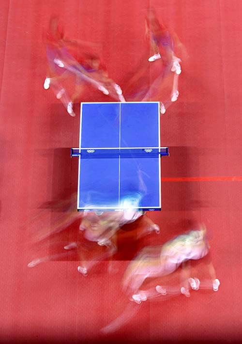 China's Qi Chen and Lin Ma (R and L top) play against Hong Kong's Lai Chak Ko and Ching Li (R and L bottom) during their men's doubles table tennis gold medal match at the Athens 2004 Olympic Games on August 21.