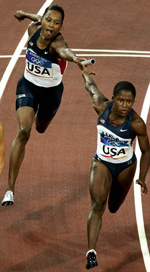 Marion Jones of the U.S. relay team, (left) fails to pass on the baton to Lauryn Williams in the women's 4 x 100 metres relay final at the Athens 2004 Olympic Games on August 27. The U.S. did not finish the race, Jamaica won the gold medal in a time of 41.73 seconds ahead of Russia and France.