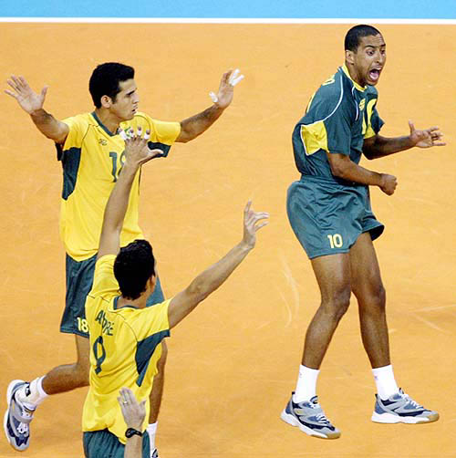 Brazil's Sergio (right) celebrates a point with team mates Dante (left) and Andre Nascimento during the men's volleyball gold medal match against Italy at the Athens 2004 Olympic Games on August 29.