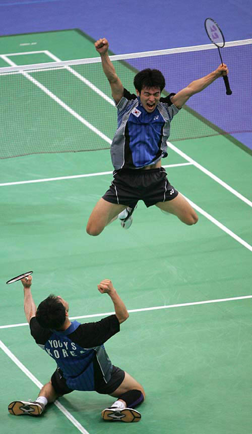 South Korea's Yoo Yong Sung (left) and Lee Dong Soo celebrate their men's doubles badminton semi-final victory over Danish opponents Jens Eriksen and H. Martin Lundgaard at the Athens 2004 Olympic Games on August 19.