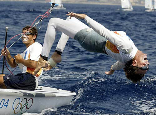 Kevin Burnham of the U.S. celebrates the gold medal with a back-flip alongside his team mate Paul Foerster in the men's 470 sailing at the Olympic Sailing Centre during the Athens 2004 Olympic Games on August 21, 2004.