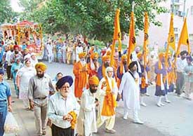 Devotees take part in a procession held to mark the 400 years of installation of Sri Guru Granth Sahib in Sector 37, Chandigarh, on Monday.