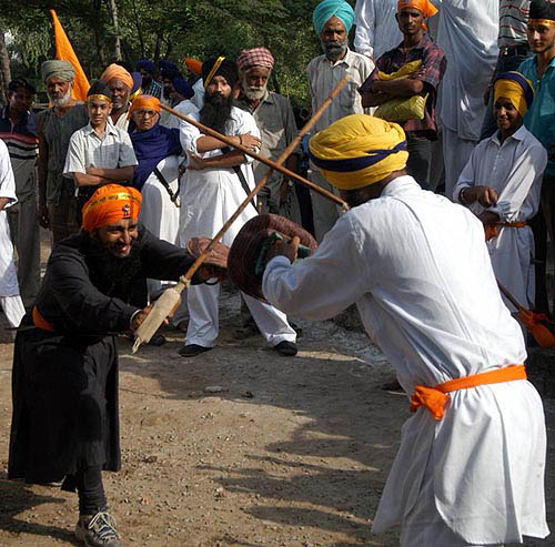 Sikhs display martial art skills by performing gatka during a religious procession