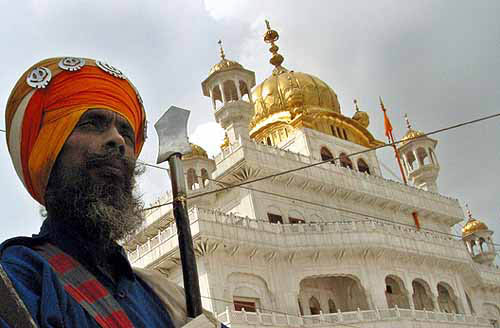 A Nihang stands outside Akal Takhat in the Golden Temple complex