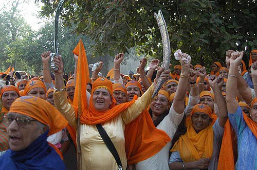 Sikh women raising religious slogans during a procession