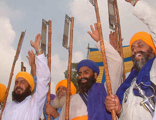 Sikh devotees raise religious slogans