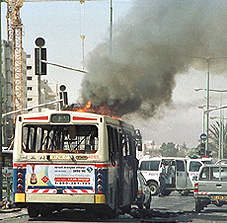 A bus burns after bomb blasts ripped through two buses in the southern Israeli city of Beersheba on Tuesday