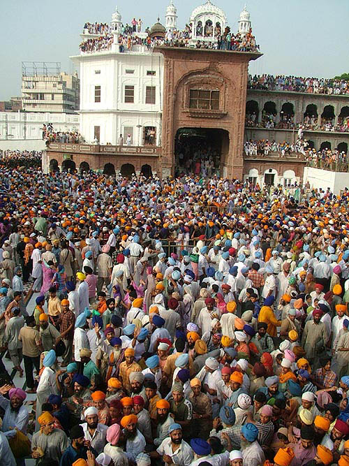 Devotees take a holy bath in the sarovar at the Golden Temple