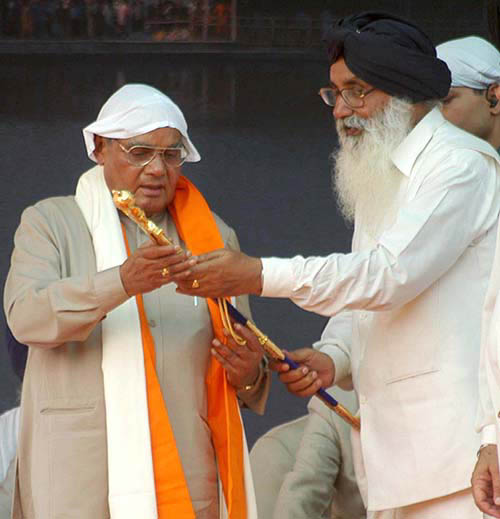 SAD chief Parkash Singh Badal presenting a sword to former Prime Minister Atal Bihari Vajpayee