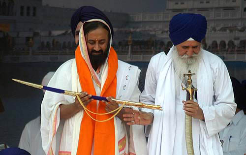 The founder of Art Living, Shree-Shree Ravi Shanker, being presented a sword