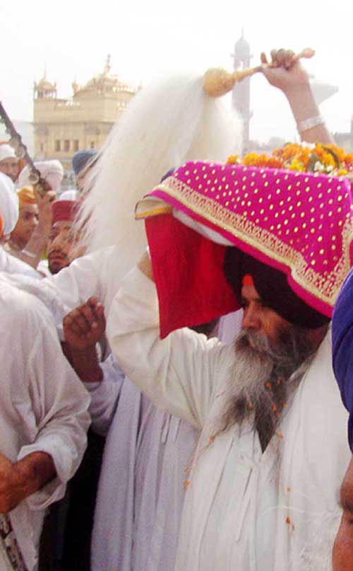 Giani Puran Singh, Head Granthi of the Golden Temple, carries Guru Granth Sahib