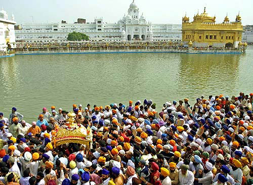 Sikh devotees carry Guru Granth Sahib during a procession 