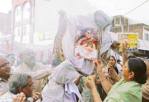 BJP activists burn an effigy of Congress President Sonia Gandhi at Ambala on Wednesday.
