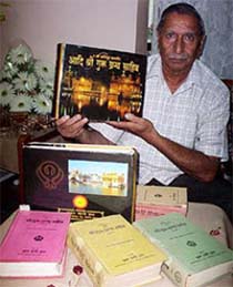Dr Manmohan Sehgal displays a translation of Guru Granth Sahib along with other works