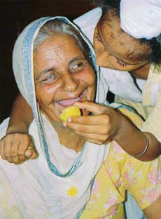 Thrilled with joy Sukhdevs mother Gurdev Kaur is offered a ladoo by her grandnephew