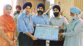 Mr Ranjodh Singh, president of the Ramgarhia Educational Council, displays a calendar that contains details of baani of six Gurus at Ramgarhia Girls College in Ludhiana on Wednesday 