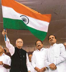 Mr L.K. Advani waves the National Flag while launching a week-long satyagraha demanding withdrawl of cases against M.S. Uma Bharti in Bangalore