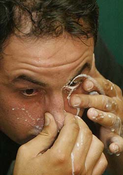 Mehmet Yilmaz snorts milk up his nose and squirts it out of his eye in a bid to set a new world record in Istanbul