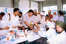 Patients being given medicines free of cost during a medical camp at Bhattan village near Amloh