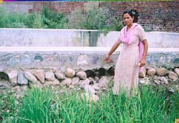 Municipal councillor Shobha Rani shows the drain that was washed away after the first rain after it was constructed.