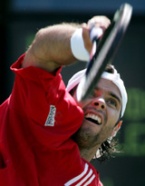Fernando Gonzalez of Chile serves to Robin Soderling of Sweden during their match at U.S. Open