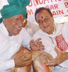 Union Minister of Youth Affairs and Sports Sunil Dutt sharing a light moment with Haryana Chief Minister O.P. Chautala after laying the foundation stone of School for Parentless Children at Bhurewala village