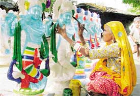 A Rajasthani sculptor busy making idols of Lord Krishna for Janmashtami