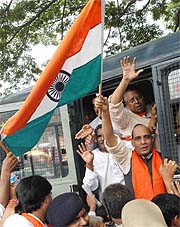 BJP leader Rajnath Singh waves the Tricolour after courting arrest in Bangalore on the third day of BJPs week-long Satyagraha demanding the withdrawal of false cases against Uma Bharti, on Friday. 
