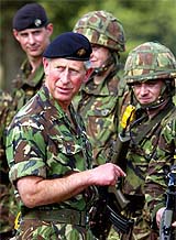 Britains Prince Charles makes a point as he talks to soldiers