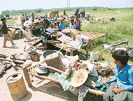 Dwellers of a slum colony near Saketri gather their meagre belongings after a demolition drive by HUDA on Saturday.