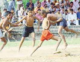 Players of  Mauli Vaidwan village tackle a Sohana village player at a kabaddi match during a rural sports festival at Dadu Majra on Saturday.