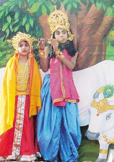 Children dressed as Radha and Krishna on a tableau taken out by the Sanatan Dharam Mahotsav Committee