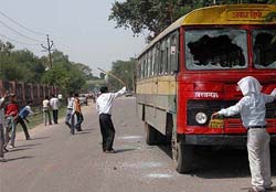 Agitating lawyers damage a roadways bus near the High Court premises in Lucknow on Saturday.