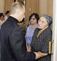 Russian President Vladimir Putin comforts a relative of a hostage in hospital in Beslan, Northern Ossetia. 