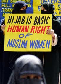 Pakistani activists of Muttahida Majlis-e-Amal (MMA), an alliance of six hardline Islamic parties, protest against the ban on headscarves in French schools
