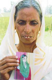 Gulzaro with a photo of her kidnapped daughter in Mohali on Sunday