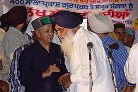 Mr Parkash Singh Badal listens to Mr Virbhadra Singh during the 400th anniversary celebrations of the installation of Guru Granth Sahib at the Paonta Sahib gurdwara