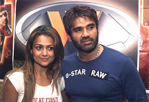 Bollywood stars Sunil Shetty and Amrita Arora pose for photographers at the premier of their film Rakht in Ahmedabad 