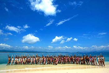 Contestants of a modelling competition take part in a photocall on a beach in Sanya