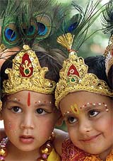 Boys dressed as Lord Krishna perform at a school on the eve of Janmashtami