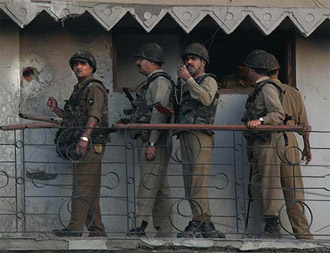 Securitymen inspect the damage caused by a rifle grenade thrown at their camp at Ikhwan Hotel in Srinagar. 