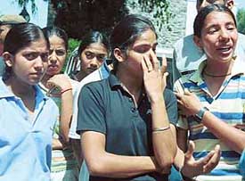 Members of the Panjab University crosscountry team cry outside the Vice-Chancellors residence in Chandigarh