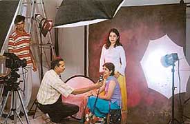 A fashion photographer gives directions to a model during a shoot