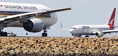 Qantas and Singapore Airlines jets manoeuvre at Sydney Airport on Wednesday after Qantas confirmed that the British Airways plans to sell its 18.25 per cent stake in Australias flag-carrier in the next two days to cut debt and take advantage of future consolidation in Europe.