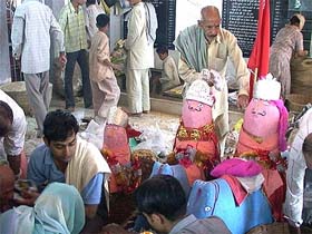 Devotees offer prashad at the Guga temple in Larha in Hamirpur district